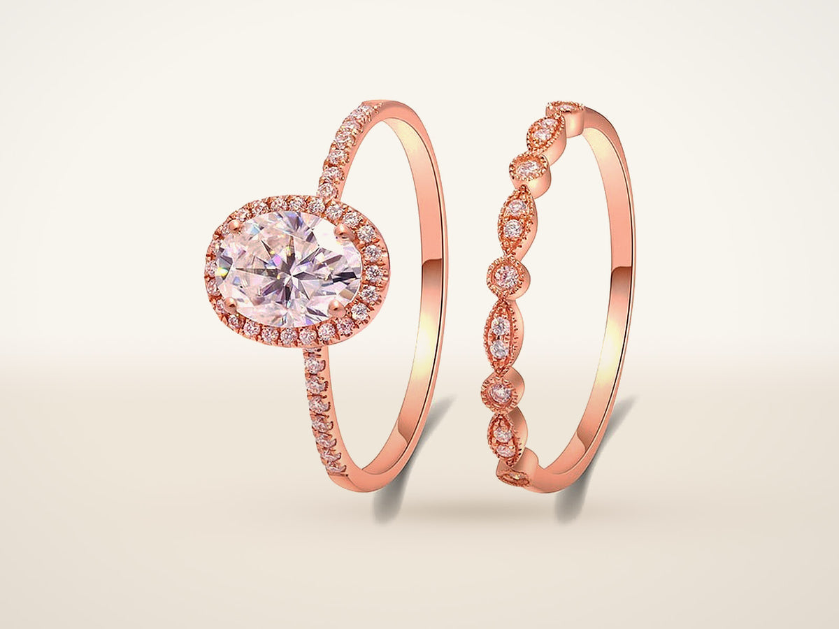 Oval moissanite halo engagement ring with a matching band in rose gold